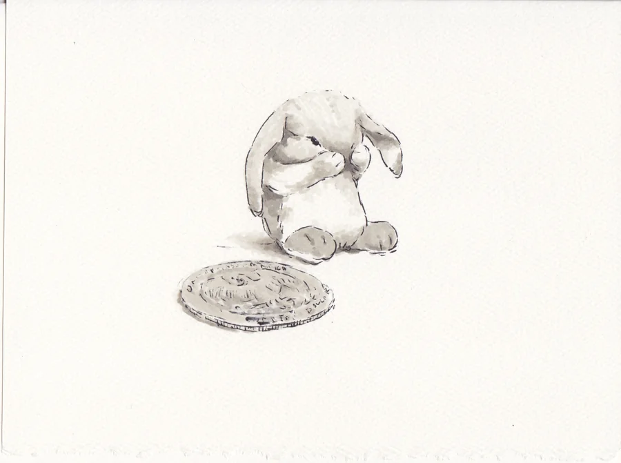 Small marker drawing of a rabbit sitting beside a quarter